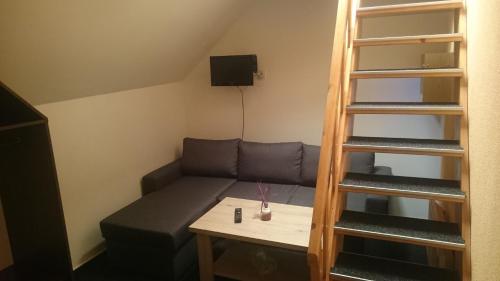 a small room with a couch and a table at Pension Harcovna in Frýdlant nad Ostravicí