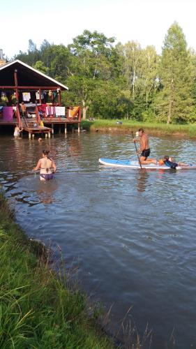 a group of people on a paddle board in the water at Brīvdienu māja Skerškāni in Krāslava