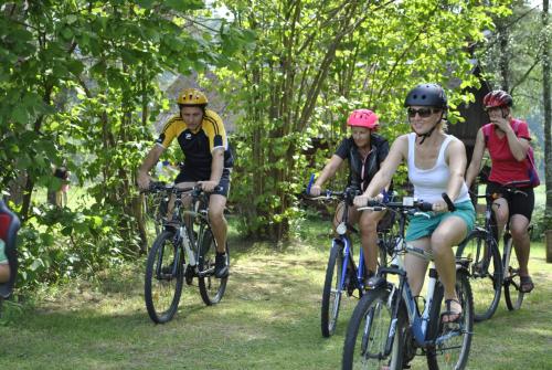 a group of people riding bikes down a trail at Brīvdienu māja Skerškāni in Krāslava