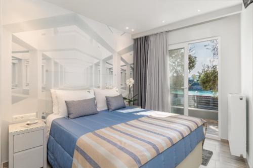 Ένα ή περισσότερα κρεβάτια σε δωμάτιο στο Odysseus Villa