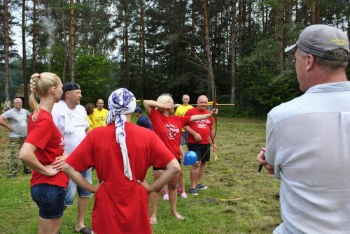a group of people standing in a field playing a game at Brīvdienu māja Skerškāni in Krāslava