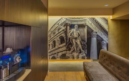 ローマにあるカンポ マルツィオ ラグジュアリー スイーツの壁面に像画が描かれた部屋