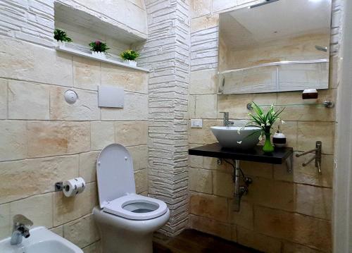 a bathroom with a toilet and a sink at Room n.22 in Taranto
