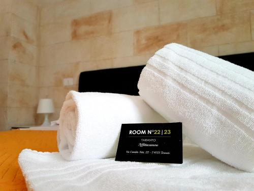 a pile of towels sitting on top of a bed at Room n.22 in Taranto