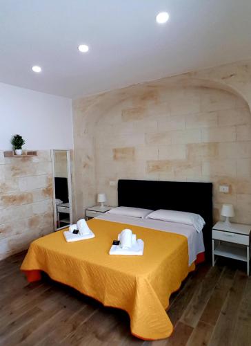 a bedroom with a bed with two towels on a table at Room n.22 in Taranto