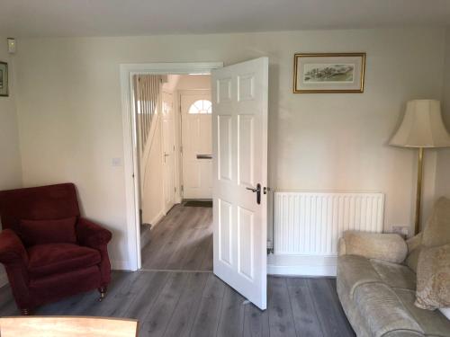 a living room with a couch and a chair at Jubilee House in Oakham