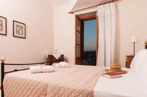 a bedroom with two beds with towels on them at The house of "Angelina", magnificent view of the sea in Methoni