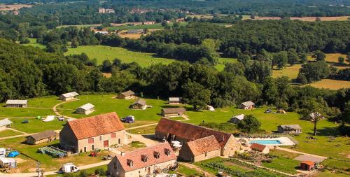 an aerial view of a small village with a house at Camping Parc de la Brenne in Lignac