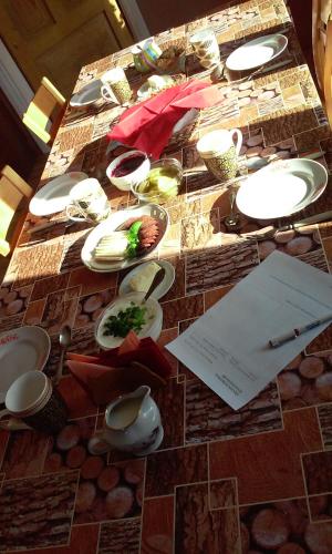 a table with plates of food on top of it at Jõeniidu Holiday House in Trolla