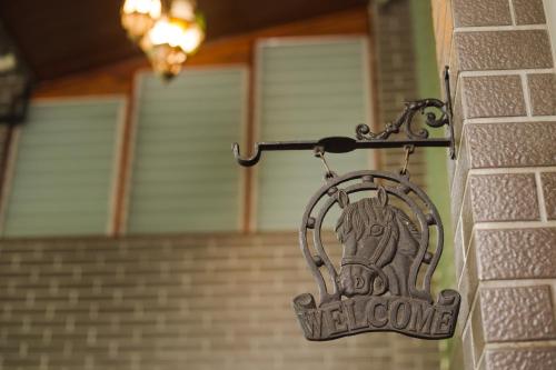 a welcome sign on a brick wall in front of a house at Narra House Sukhumvit58 in Bangkok