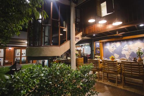 a restaurant with a table and chairs in a building at Narra House Sukhumvit58 in Bangkok