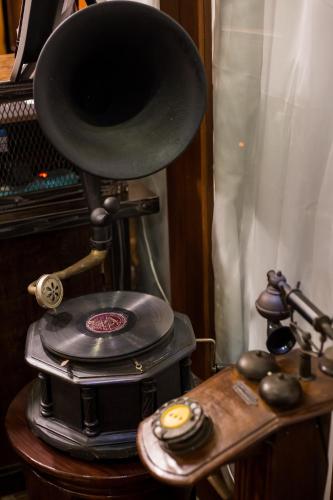 a record player sitting on a table next to a piano at Narra House Sukhumvit58 in Bangkok