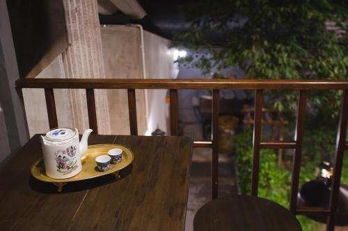 a cup and saucer on a table on a balcony at Narra House Sukhumvit58 in Bangkok