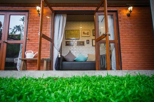 a room with a couch inside of a house at Narra House Sukhumvit58 in Bangkok