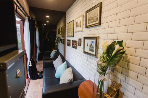a room with couches and pictures on the wall at Narra House Sukhumvit58 in Bangkok