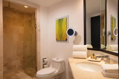 a bathroom with a toilet and a sink and a shower at Krystal Grand Nuevo Vallarta in Nuevo Vallarta 