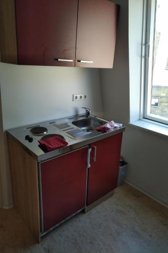 a small kitchen with a sink and a counter at FeWos im alten Bahnhof in Lauterecken
