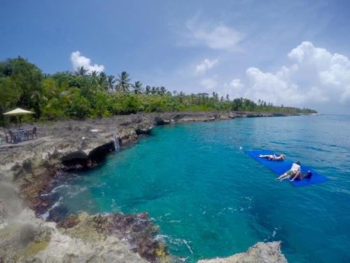 two people in the water on a raft in the ocean at Ocean View Sai in San Andrés