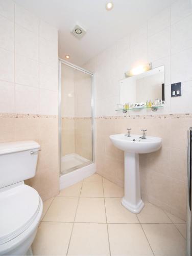 a bathroom with a toilet and a sink and a shower at Lobster Hall - Room Only in Whitby
