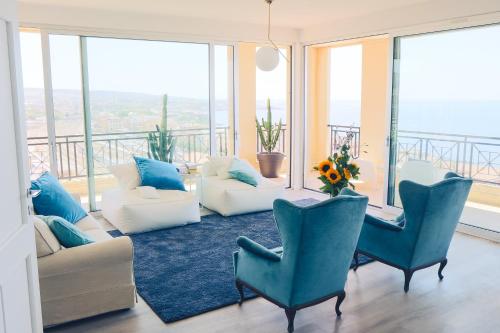 a living room with couches and chairs and windows at B&B Seataly by W Signature Experiences in Civitavecchia