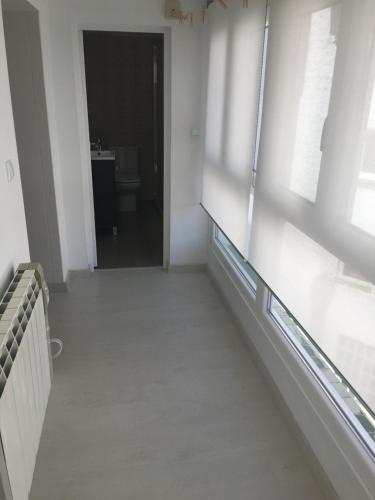 an empty room with a hallway with a window at Castro Sun And Beach in Castro-Urdiales