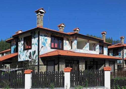 a house with a fence in front of it at Ruskovets Thermal SPA & Ski Resort in Bansko