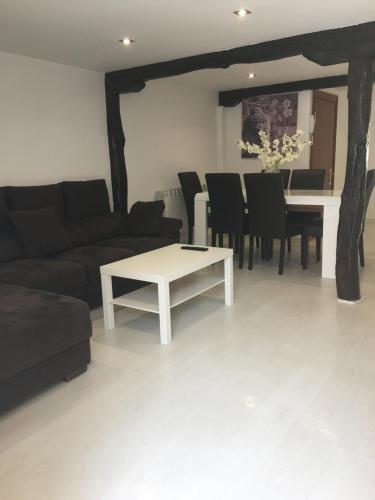 a living room with a couch and a table at Castro Sun And Beach in Castro-Urdiales