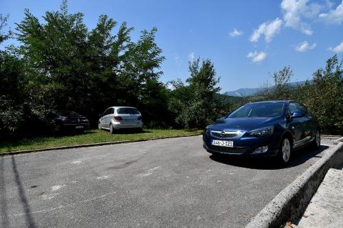 a blue car parked on the side of a road at Keep calm Lake edition in Konjic