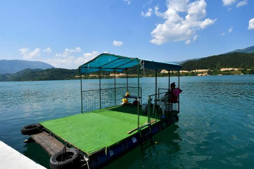 a person standing on a boat in the water at Keep calm Lake edition in Konjic