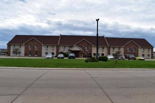 a large building with cars parked in front of it at Days Inn by Wyndham Grand Island in Grand Island