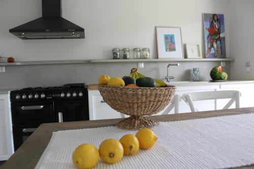 a bowl of fruit on a table in a kitchen at Akti Elia Villas Beachfront Chalkidiki in Elia