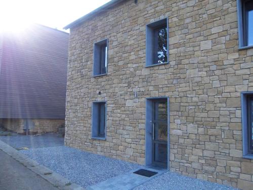 a brick building with a door on the side of it at Les hauts de Meez in Dinant