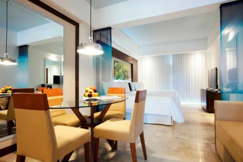 a room with a dining table and a bedroom at Krystal Grand Nuevo Vallarta in Nuevo Vallarta 