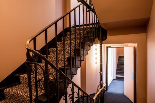 a black spiral staircase in a house at Hôtel du Rond-point des Champs-Élysées - Esprit de France in Paris
