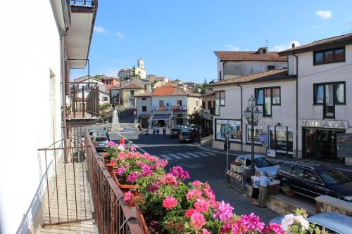 a view of a city street with flowers on a balcony at La Maison in Vallata