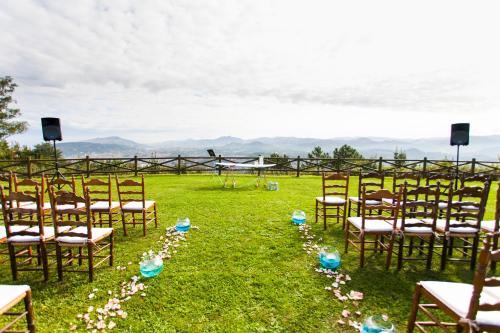 a row of chairs in a field with flowers at Hotel Gudamendi in Donostia-San Sebastián