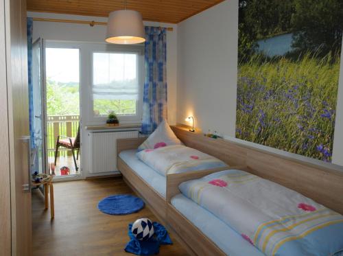 a room with two beds in it with a window at Ferienwohnungen Ströhlein in Absberg