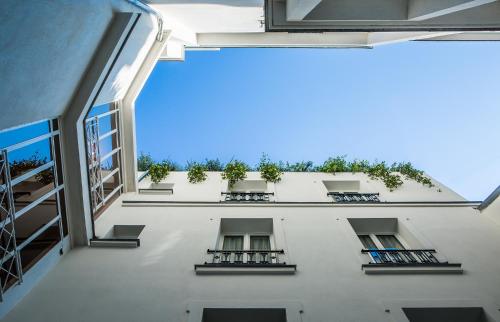 a view from the inside of a building with plants at Hôtel du Rond-point des Champs-Élysées - Esprit de France in Paris