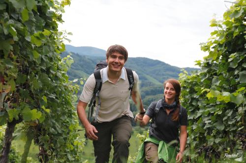 a man and a woman walking through a vineyard at Hotel Restaurant Rebstock in Oppenau