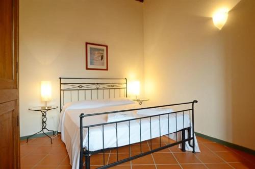 a bedroom with a bed and a lamp on a floor at Vinaio a Montefiorile in San Sano