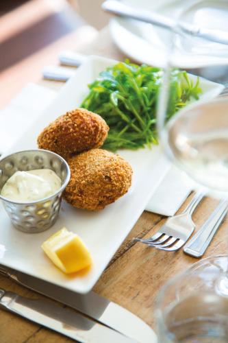 a plate of food with meatballs and cheese on a table at Twin Oaks Hotel in Chesterfield