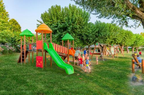 a group of children playing on a playground at Camping Village Du Parc in Lazise