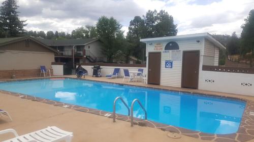 a swimming pool with a building next to it at Sierra Inn in Prescott