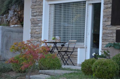 a table and chairs on the porch of a house at MAPLE place in Pivka