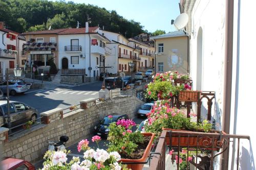 a view of a town with flowers on a balcony at La Maison in Vallata