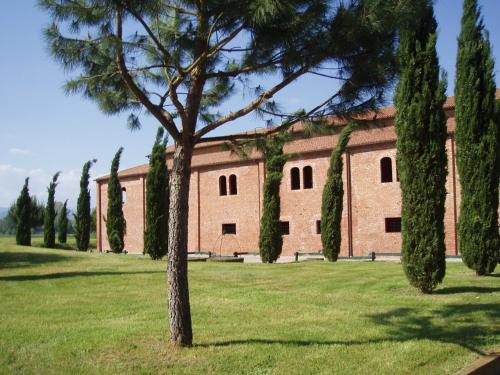 a large brick building with trees in front of it at Agriturismo Settepassi Tuscany in Ponte Buggianese