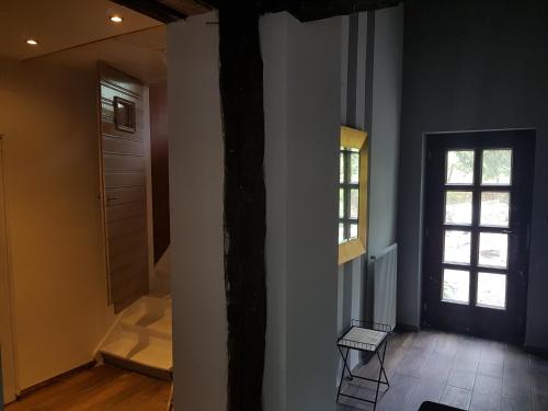 a room with a hallway with a door and a window at Forester in Malmedy