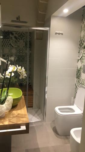 a bathroom with a toilet and a sink at Egusa73 Favignana in Favignana