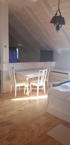 a room with a white table and two chairs at Guest House Kozjak in Sveti Križ Začretje