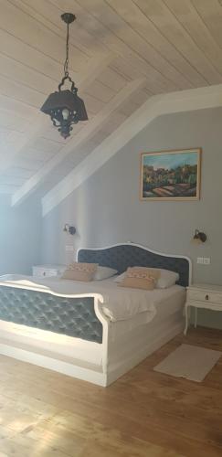 a large bed in a room with a ceiling at Guest House Kozjak in Sveti Križ Začretje